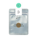 A silver Hudson Cannabis package with a green seal sticker on top.