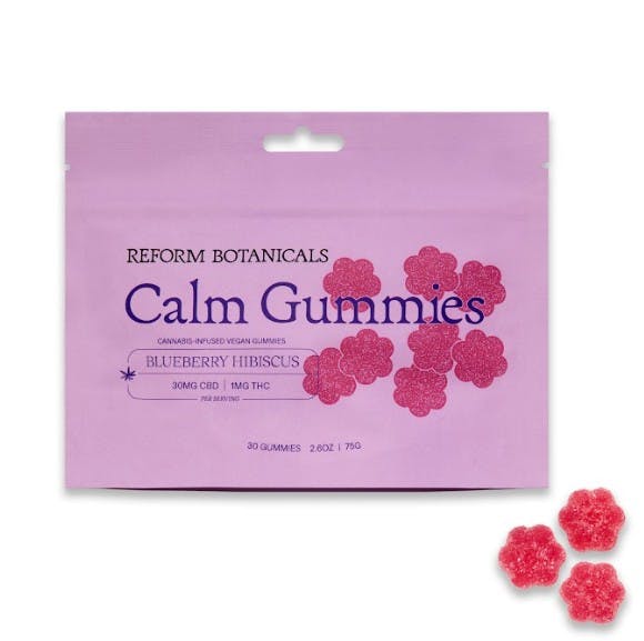 A pink pouch labeled Calm Gummies with red flower-shaped gummies beside it.