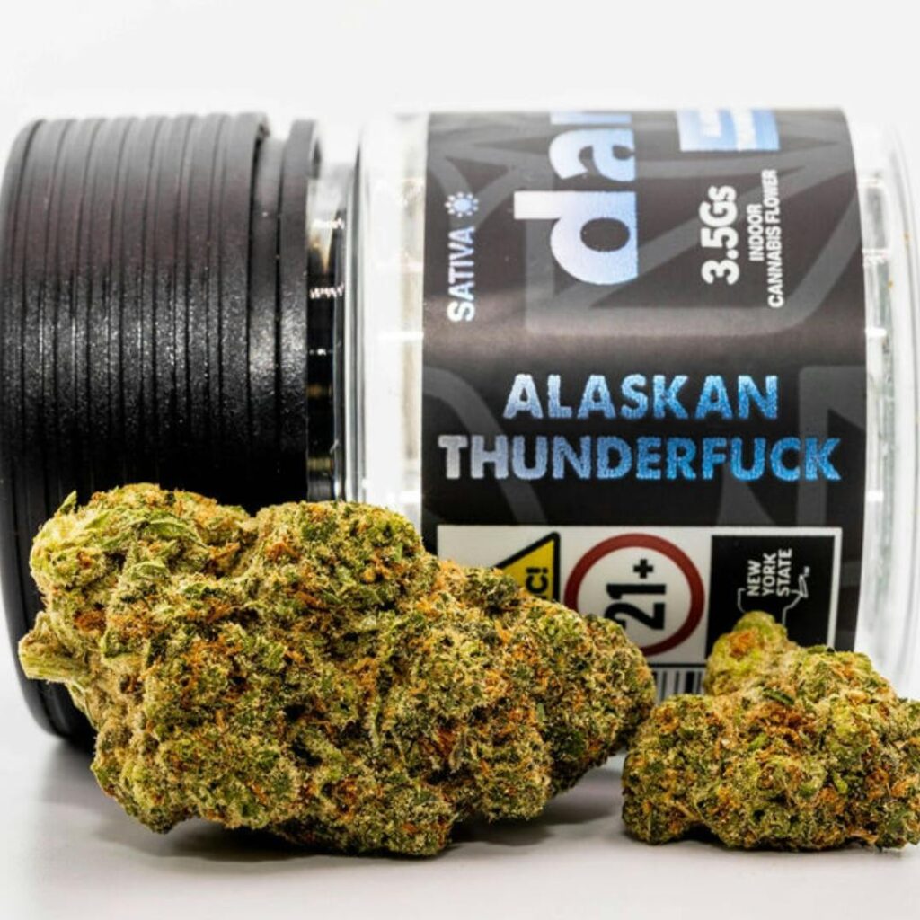 Cannabis buds in front of a labeled jar reading Alaskan Thunderfuck, 3.5g, Sativa, 21+.
