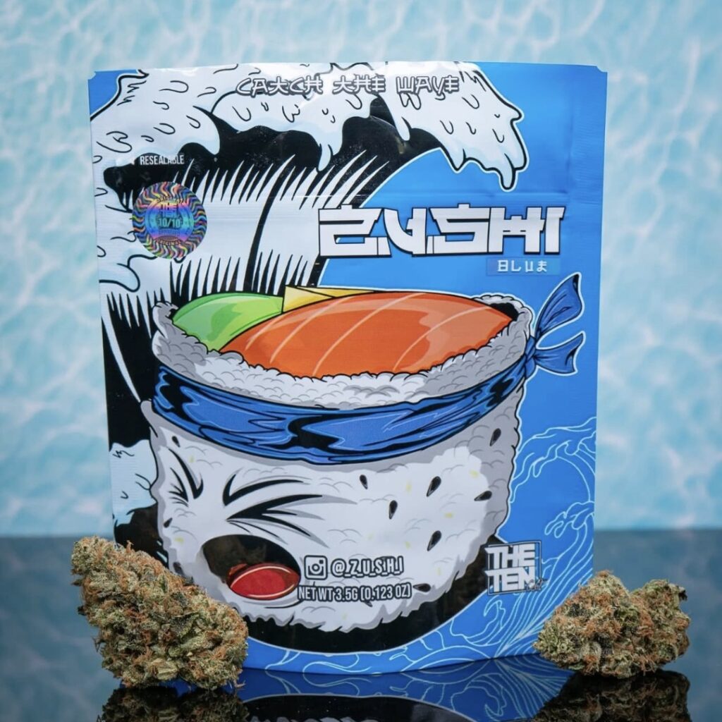 A blue Zushi BLU package with sushi art, placed between two Blue Zuchi strain cannabis buds on a blue background.