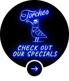 Neon sign with a bird smoking, text reads: Torches. Check out our specials with an arrow below.