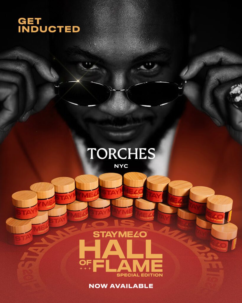 A man lowers STAYME7O sunglasses above stacks of StayMe7o Torches NYC jars, promoting the Hall of Flame Special Edition.