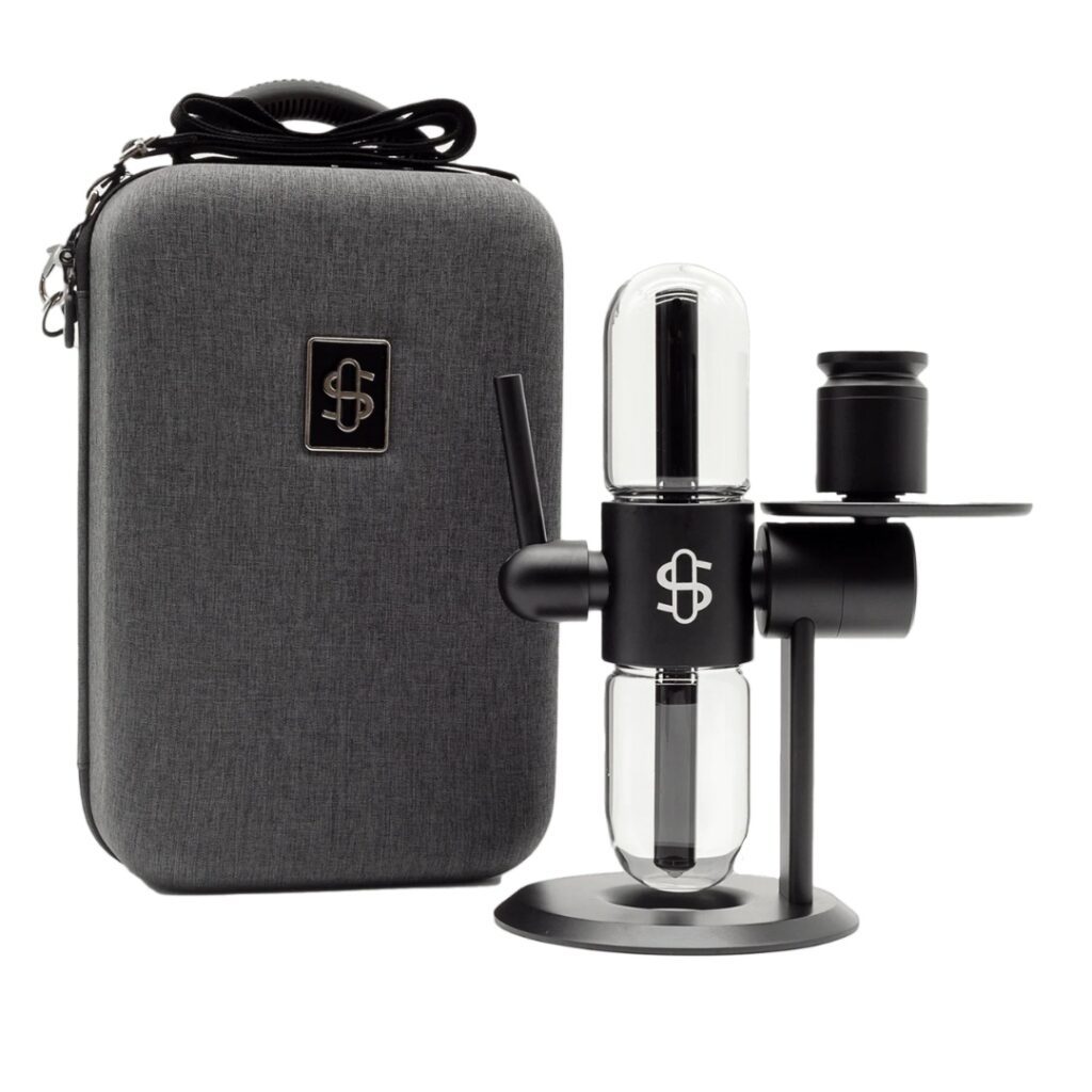 A modern black and glass tabletop device next to a gray carrying case with a logo on both items.